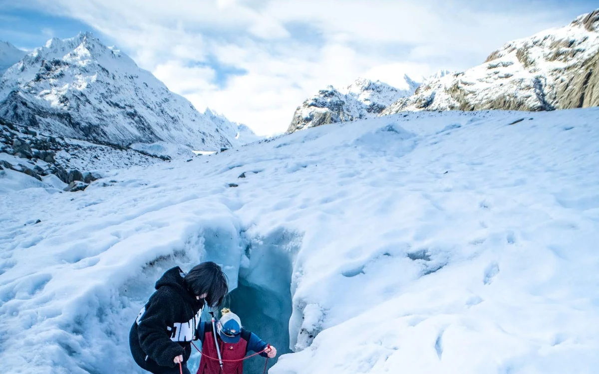 A guided group in crampons walking on the Tasman Glacier