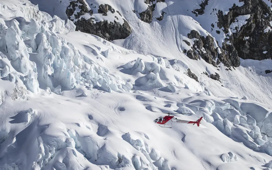 A helicopter on a high snowfield in Aoraki Mount Cook National Park